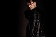 © LIGHTFIELD STUDIOS - trendy man in glasses and leather jacket standing on black