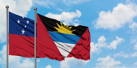 Samoa and Antigua and Barbuda flag waving in the wind against white cloudy blue sky together. Diplomacy concept, international relations.