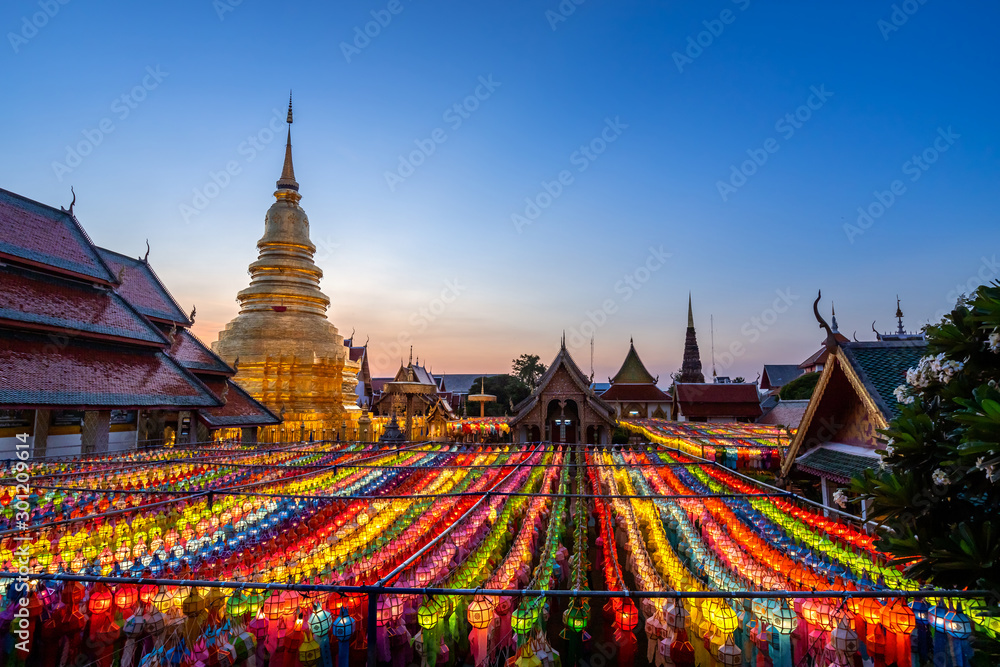 The light of the Beautiful Lanna lamp lantern are northern thai style lanterns in Loi Krathong or Yi Peng Festival at Wat Phra That Hariphunchai is a Buddhist temple in Lamphun, Thailand. - obrazy, fototapety, plakaty 