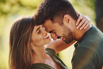 feeling good to be together. beautiful young couple have a good time in the forest at daytime