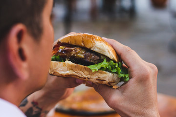 young man with hamburger