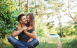 © standret - Sitting and embracing. Beautiful young couple have a good time in the forest at daytime