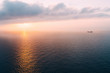 © gemma ferrando & jeremie roman/Westend61 - Cargo ship sailing towards sunset at horizon, Mallorca, Spain