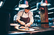 © Oscar Carrascosa Martinez/Westend61 - Cook serving food on a plate in the kitchen, of a restaurant