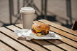 © Vasily Pindyurin/Westend61 - Close-up of cheeseburger and take-out coffee on wooden table