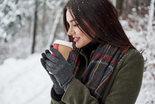 Time To Heat. Girl In Warm Clothes With Cup Of Coffee Have A Walk In The Winter Forest