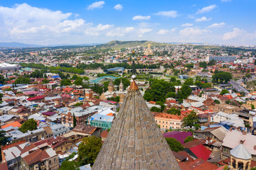 Wall Mural - Panoramic view of Tbilisi city from the Narikala Fortress, old town and modern architecture. Dome and cross of Upper Bethlehemi Church