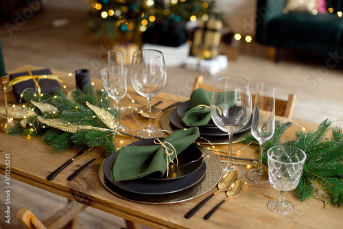 Fotografía Table served for Christmas dinner in living room, close-up view, table setting, Christmas decoration