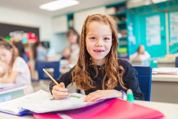 Wall Mural - education and school concept little student girl studying at school