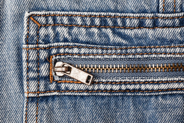 Blue jeans denim metal zipper. Fashion fabric background.