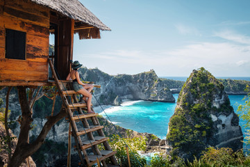 traveler on tree house at diamond beach, nusa penida island, bali, indonesia