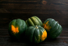 Rustic Grouping Of Acorn Squash On A Dark Wood Background