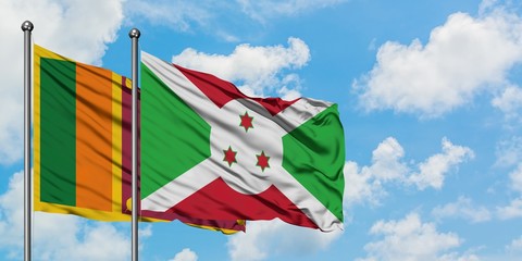 Sri Lanka and Burundi flag waving in the wind against white cloudy blue sky together. Diplomacy concept, international relations.