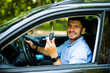© F8  \ Suport Ukraine - Young driver man sitting inside new car with keys. Smiling