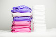 Stacks of eco friendly washable textile diapers and modern disposable diapers together.