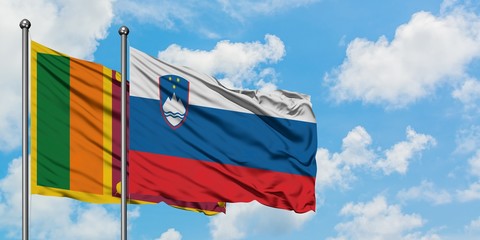 Sri Lanka and Slovenia flag waving in the wind against white cloudy blue sky together. Diplomacy concept, international relations.