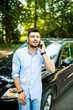 © F8  \ Suport Ukraine - Attractive young man talking on phone near luxury car outdoors