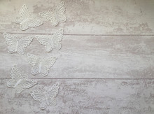 White Cotton Lace Butterflies On The Light Grey Wooden Background, Top View, Flat Lay