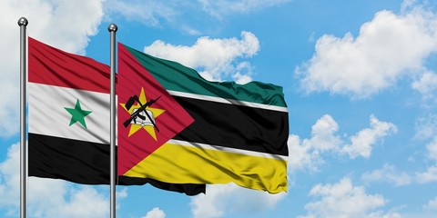 Syria and Mozambique flag waving in the wind against white cloudy blue sky together. Diplomacy concept, international relations.