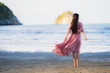 © siraphol - Portrait young beautiful asian woman walk smile and happy on the beach sea and ocean