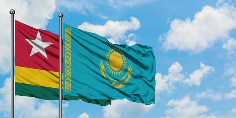 Togo and Kazakhstan flag waving in the wind against white cloudy blue sky together. Diplomacy concept, international relations.