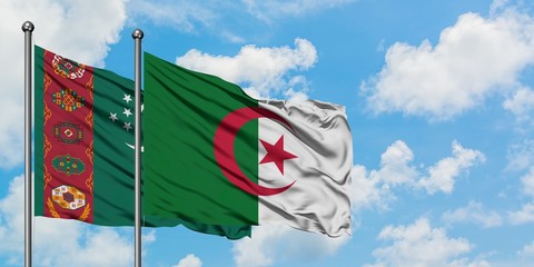 Turkmenistan and Algeria flag waving in the wind against white cloudy blue sky together. Diplomacy concept, international relations.