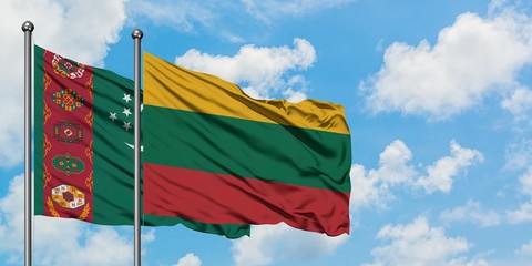 Turkmenistan and Lithuania flag waving in the wind against white cloudy blue sky together. Diplomacy concept, international relations.