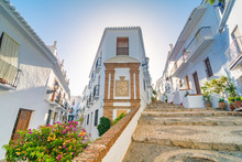 Quiet Street Of The Town Of Frigiliana, A Traditional White Village In The Mountain Of The Coast Of Malaga, Spain.