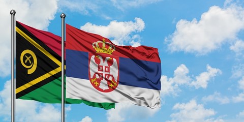 Vanuatu and Serbia flag waving in the wind against white cloudy blue sky together. Diplomacy concept, international relations.