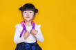 © paulaphoto - Portrait of young happy little asian girl in uniform isolated on yellow background with copy space. Education for toddler or preschool, childhood lifestyle back to school concept