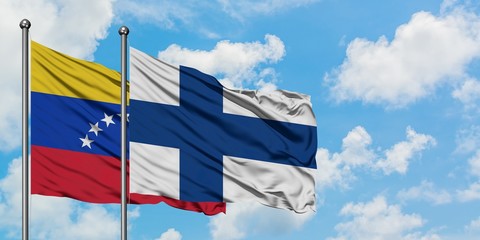 Venezuela and Finland flag waving in the wind against white cloudy blue sky together. Diplomacy concept, international relations.