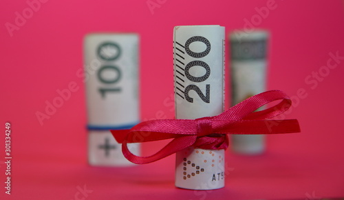 Cuadros en Lienzo Rolled banknotes of 200 Polish zloty tied with red ribbon concept of economical