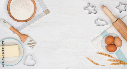 Fotomural Holiday baking cookies concept with dough ingredients on wooden table