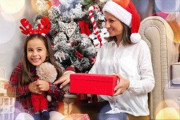 Happy family mother and daughter giving Christmas  gift