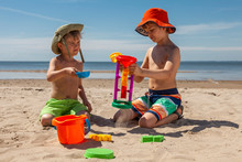 Two Boys Sitting On The Sea Beach Playing Sand With Beach Toys. Happy Children Kid Enjoy And Fun Outdoor Lifestyle On Beach Holiday. Together On Summer Vacation.
Beach Toys In The Sand.
