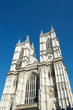 Bright sunny exterior view of Westminster Abbey under blue sky in London, UK