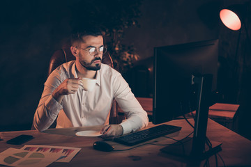 Sticker - Profile side photo of freelancer man sit table desk work on pc computer under lamp drink coffee try finish presentation for his executive senior manager stay focused in dark evening loft workstation