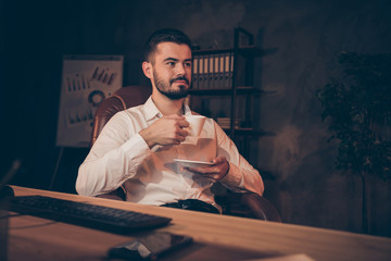 Sticker - Profile side photo of peaceful dreamy marketer man sit armchair table hold drink double espresso have relax before finishing project want be energetic in dark evening loft enterprise office