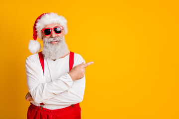 Poster - 2020 christmas resolution discounts. Funny funky grey hair santa claus in red hat point index finger indicate x-mas time sales isolated over yellow color background