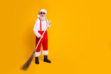 Full Size Photo Of Funky Funny Bearded Grandfather Worker In Santa Claus Hat Enjoy X-mas Time Christmas Noel Wipe Broom Wear Trousers Black Boots Isolated Over Shine Color Background
