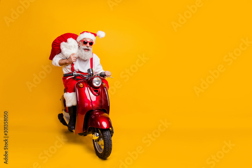 Fotomural Full body photo of crazy funny santa claus in red hat drive hurry fast motor cyc