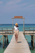 © allenkayaa - Woman in a hat on a pier near the clear turquoise sea