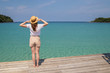 © allenkayaa - Woman in a hat on a pier near the clear turquoise sea