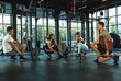 © master1305 - A group of muscular athletes doing workout at the gym. Gymnastics, training, fitness workout flexibility. Active and healthy lifestyle, youth, bodybuilding. Training with weights, doing squats.