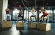 © master1305 - A group of muscular athletes doing workout at the gym. Gymnastics, training, fitness workout flexibility. Active and healthy lifestyle, youth, bodybuilding. Training with sportive jump boxes.