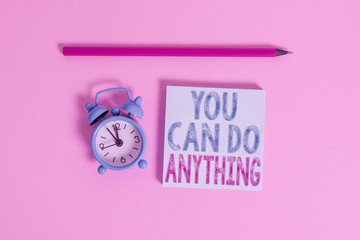 Word writing text You Can Do Anything. Business photo showcasing Motivation for doing something Believe in yourself Metal vintage alarm clock wakeup blank notepad marker colored background