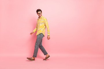 Poster - Full size profile photo of handsome business guy going down street finished working week wear specs stylish striped shirt pants isolated pink color background