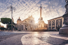 Catania Dome Square At The Sunset And The Famous Landmark Elephant Fountain Also Know As "liotru" By The Indigenous People. Cloudy Sky And Marvelous Sun Light.