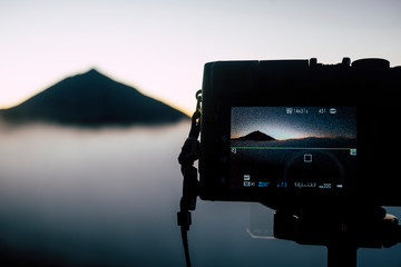 Close up of photography display camera showing beautiful landscape taken and exif of he pictures -technical details of shooted pict - technology and nature outdoor leisure activity