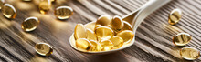 Golden Fish Oil Capsules In Spoon On Wooden Table, Panoramic Shot